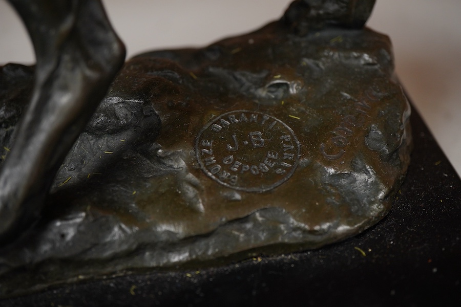 A patinated bronze of a hunting dog, signed Coreira, on black marble base, 36cm wide